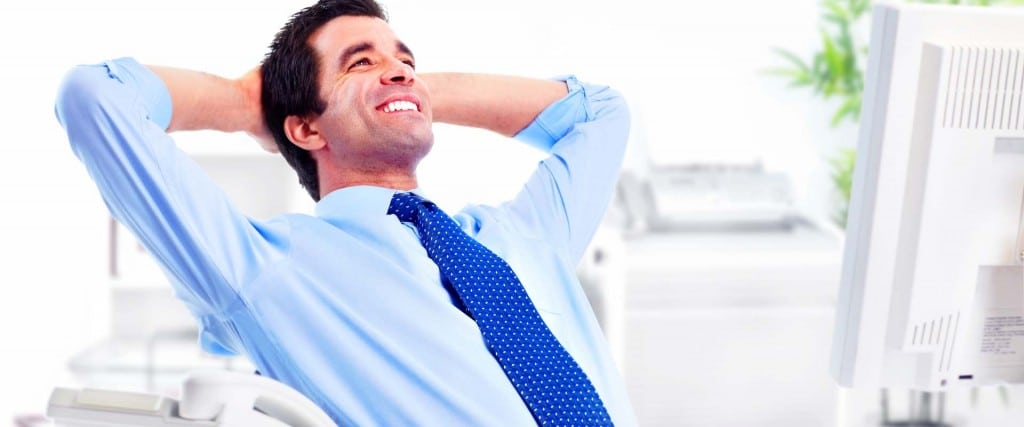 Smiling handsome businessman relaxing  in a modern office.